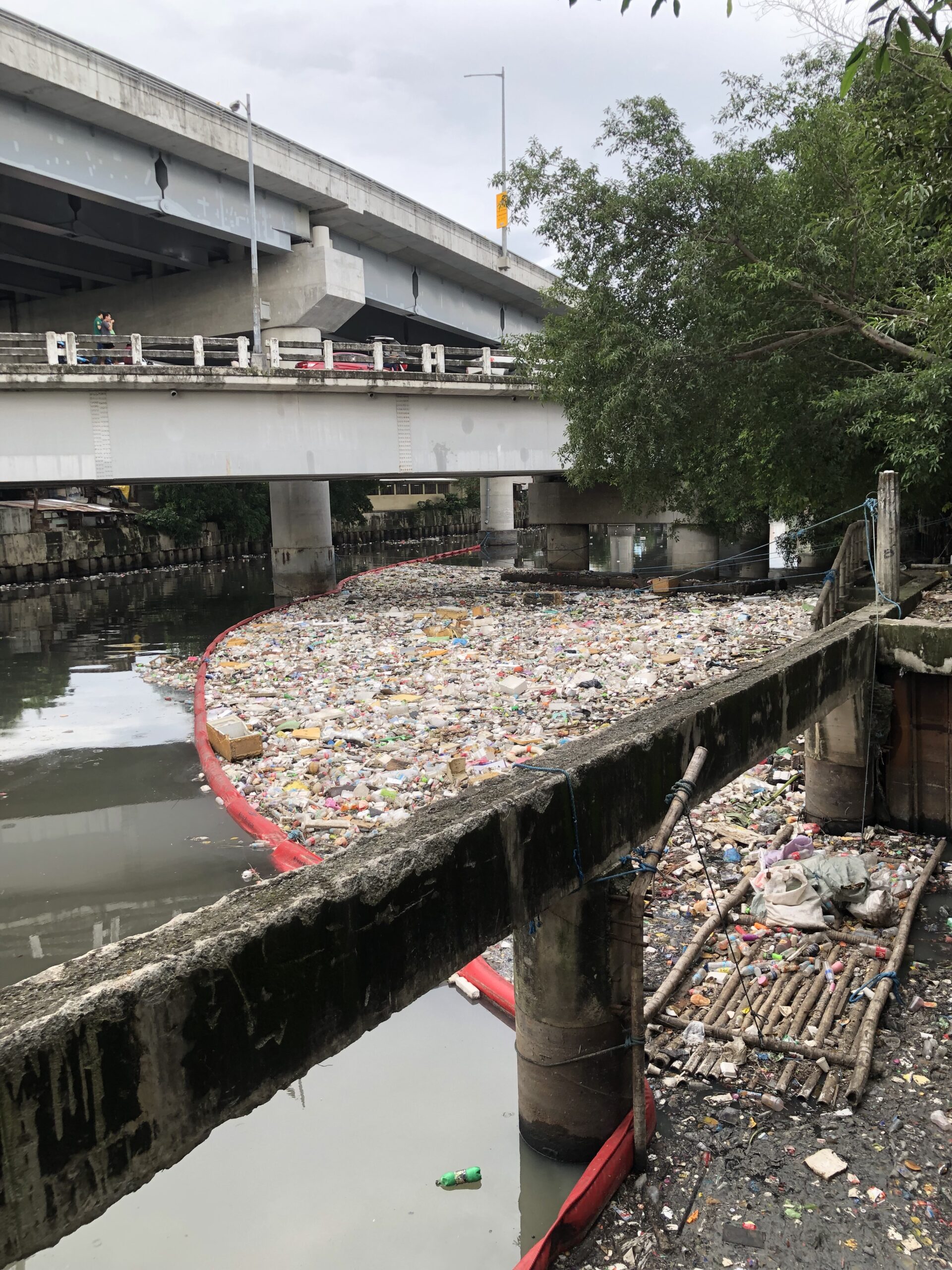RiverRecycle floating boom catching plastic waste on the San Juan River in Manila, a tributary of the Pasig River